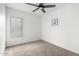 Bright bedroom features neutral carpet, a modern ceiling fan, and a window at 3008 S Saguaro Cir, Mesa, AZ 85202