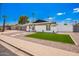 Attractive, renovated single-story house featuring a well-kept yard with rock and grass at 3008 S Saguaro Cir, Mesa, AZ 85202