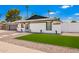 Attractive, renovated single-story house featuring a well-kept yard with rock and grass at 3008 S Saguaro Cir, Mesa, AZ 85202