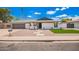 Charming single-story home with a manicured lawn and desert-friendly landscaping at 3008 S Saguaro Cir, Mesa, AZ 85202