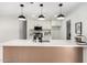 Modern kitchen with white cabinets, stainless steel appliances, and an island with a quartz countertop at 3008 S Saguaro Cir, Mesa, AZ 85202
