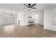 Open-concept living room with modern lighting, neutral walls, and light wood-look floors at 3008 S Saguaro Cir, Mesa, AZ 85202