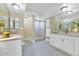 Elegant bathroom with a walk-in shower, double sink vanity, and decorative lighting at 34 E Boca Raton Rd, Phoenix, AZ 85022