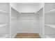 Walk-in closet with custom shelving and wood floors, providing ample storage space at 34 E Boca Raton Rd, Phoenix, AZ 85022