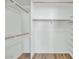 Walk-in closet with hanging rods and built-in shelves, offering storage and organization at 34 E Boca Raton Rd, Phoenix, AZ 85022