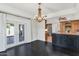 Bright dining area with dark floors, a chandelier, and an open view into the kitchen, perfect for entertaining at 34 E Boca Raton Rd, Phoenix, AZ 85022