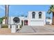 Charming white two-story home with a red front door, desert landscaping, and a two-car garage at 34 E Boca Raton Rd, Phoenix, AZ 85022