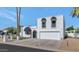 Stunning white home featuring black awnings, desert landscaping, and a paved driveway with a two-car garage at 34 E Boca Raton Rd, Phoenix, AZ 85022
