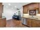 Functional kitchen with wood cabinets, granite countertops, and a bar area for casual dining at 34 E Boca Raton Rd, Phoenix, AZ 85022