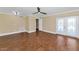 Spacious living room with tile flooring, ceiling fan, tan walls, and glass paneled doors leading to the outside at 34 E Boca Raton Rd, Phoenix, AZ 85022