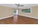 Bright living room boasts tile flooring, a ceiling fan, tan walls, and a large window with blinds at 34 E Boca Raton Rd, Phoenix, AZ 85022