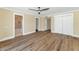 Main bedroom with walk-in closet, wood floors, neutral walls, ceiling fan and access to bath at 34 E Boca Raton Rd, Phoenix, AZ 85022