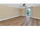 Cozy main bedroom featuring wood floors, neutral walls, and a bright window at 34 E Boca Raton Rd, Phoenix, AZ 85022