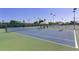 Outdoor tennis courts with blue and green surfaces, surrounded by fencing and trees, under a clear blue sky at 34 E Boca Raton Rd, Phoenix, AZ 85022