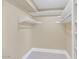 Empty walk-in closet features built-in shelving with adjustable rails for custom storage solutions at 34 E Boca Raton Rd, Phoenix, AZ 85022