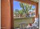 Balcony with lattice and furnishings overlooking lush greenery and blue skies at 3600 N Hayden Rd # 2310, Scottsdale, AZ 85251