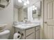 This is a bright bathroom featuring a gray-white vanity, a toilet and a door at 3600 N Hayden Rd # 2310, Scottsdale, AZ 85251
