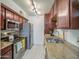 Modern kitchen featuring stainless steel appliances, granite countertops, and warm wood cabinetry at 3600 N Hayden Rd # 2310, Scottsdale, AZ 85251