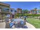 A patio area features tables with chairs and a grill in a condo community at 3600 N Hayden Rd # 2310, Scottsdale, AZ 85251
