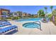 Community pool and hot tub with lounge chairs under blue skies and sunny day at 3600 N Hayden Rd # 2310, Scottsdale, AZ 85251