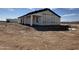 Side view of a new build house showing the building wrap and framed windows at 37459 W Missouri Ave, Tonopah, AZ 85354