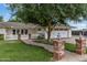 Charming single-story home featuring a landscaped front yard, brick pathway, white picket fence, and an attached garage at 3817 E Highland Ave, Phoenix, AZ 85018