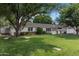 Well-manicured front yard with lush green lawn and charming white picket fence at 3817 E Highland Ave, Phoenix, AZ 85018