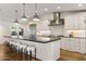 Modern kitchen features a large island with seating, stainless steel appliances, and white cabinetry at 3817 E Highland Ave, Phoenix, AZ 85018