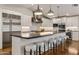 Bright kitchen boasts a large island with seating, stainless steel appliances, and sleek white cabinets at 3817 E Highland Ave, Phoenix, AZ 85018