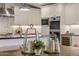 Stylish kitchen with stainless steel appliances, white cabinets, granite countertops, and decorative centerpieces at 3817 E Highland Ave, Phoenix, AZ 85018