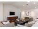 Comfortable living area with hardwood floors, sectional sofa, modern TV, and cozy decor at 3817 E Highland Ave, Phoenix, AZ 85018