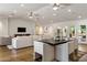 Spacious living and dining area with hardwood floors, neutral furniture, and glass doors to the patio at 3817 E Highland Ave, Phoenix, AZ 85018
