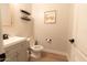 Neutral powder room with wooden floor, stylish fixtures, and a decorative 'home' sign at 4064 E Reins Rd, Gilbert, AZ 85297