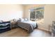 Sun-filled bedroom features hardwood floors, a comfortable bed, and a large window with a view at 4064 E Reins Rd, Gilbert, AZ 85297