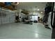 Spacious garage with multiple car capacity, storage shelves, and a golf cart at 4064 E Reins Rd, Gilbert, AZ 85297