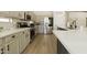 Modern kitchen with stainless steel appliances, gray cabinets, quartz countertops, and wood floors at 4064 E Reins Rd, Gilbert, AZ 85297