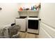 Bright laundry room featuring a modern washer and dryer, shelves, and ample storage space at 4064 E Reins Rd, Gilbert, AZ 85297