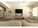 Bright living area boasts hardwood flooring, modern furniture, and a large flat-screen TV at 4064 E Reins Rd, Gilbert, AZ 85297