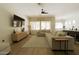 Open-concept living room featuring hardwood floors, a large sectional, and stylish decor at 4064 E Reins Rd, Gilbert, AZ 85297