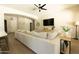 Comfortable living area with hardwood flooring, a large sectional, and a flat-screen TV at 4064 E Reins Rd, Gilbert, AZ 85297