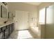 Bright main bathroom featuring a double vanity, marble floors, and a separate shower and tub at 4064 E Reins Rd, Gilbert, AZ 85297