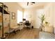 Comfortable home office space with wood floors, a modern desk setup, and natural light at 4064 E Reins Rd, Gilbert, AZ 85297