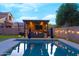 Relaxing pool area with an outdoor kitchen, a lounge and lovely landscaping, perfect for outdoor living at 4064 E Reins Rd, Gilbert, AZ 85297