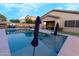 Backyard pool with sun loungers, privacy fencing, and artificial grass at 4064 E Reins Rd, Gilbert, AZ 85297