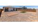 Spacious backyard with a gravel area, a square of artificial grass, and a brick-paved area at 40918 W Hillman Dr, Maricopa, AZ 85138