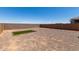 Large, private backyard with gravel, artificial turf, and brick detail, perfect for entertaining at 40918 W Hillman Dr, Maricopa, AZ 85138