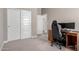 Neutral bedroom featuring carpet flooring, an office chair, and large closet at 40918 W Hillman Dr, Maricopa, AZ 85138
