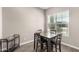 Cozy dining area with seating for four and a bar cart, illuminated by natural light at 40918 W Hillman Dr, Maricopa, AZ 85138