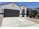 Charming single-Gathering home featuring a stucco exterior, a two-car garage, and an inviting front entrance at 40918 W Hillman Dr, Maricopa, AZ 85138