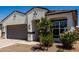 Beautiful single-story home featuring desert landscaping, a two-car garage, and a covered entry at 40918 W Hillman Dr, Maricopa, AZ 85138